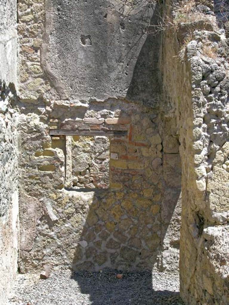 V.27 Herculaneum. May 2005.
Looking towards north wall of rear corridor/room with small window into second room, on north side of corridor. 
Photo courtesy of Nicolas Monteix.
